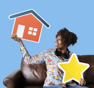 Cheerful woman holding a house and star icons